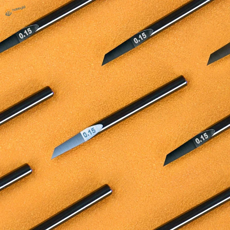 0.15mm black-handled ceramic engraving knife bits on orange surface