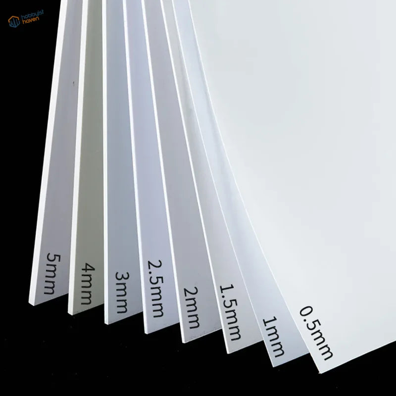 White styrene sheets 0.5mm to 5mm thick fanned out labeled on black background
