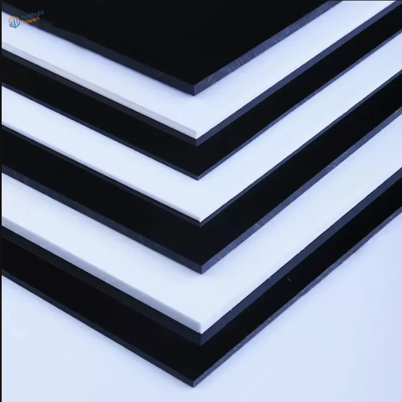 Stacked white styrene sheets, 0.5-3mm thick, glossy acrylic surfaces