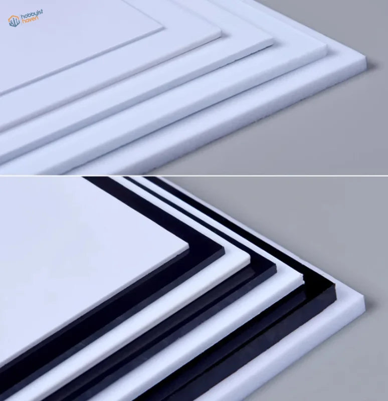Stacked white and black styrene sheets, 0.5-3mm thick, glossy surfaces