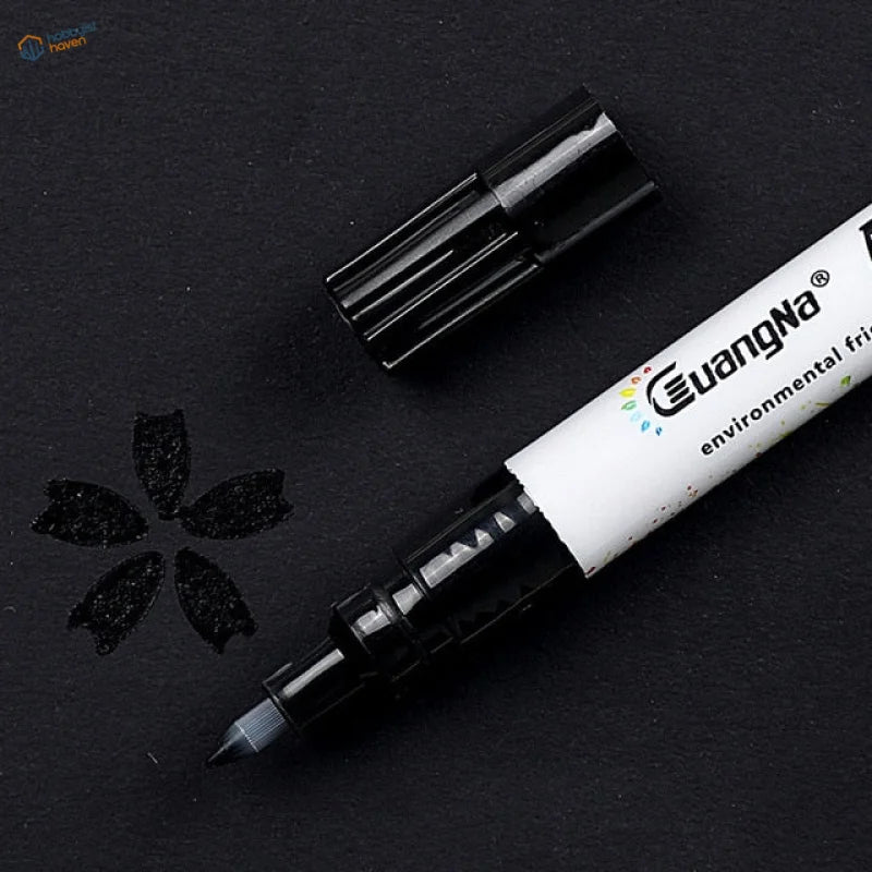 Black 0.7mm acrylic paint marker pen with white barrel, black cap, eco label