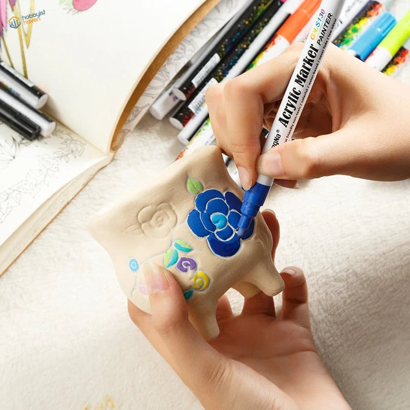 Hand-painted ceramic pig with floral designs using 0.7mm acrylic paint marker pen