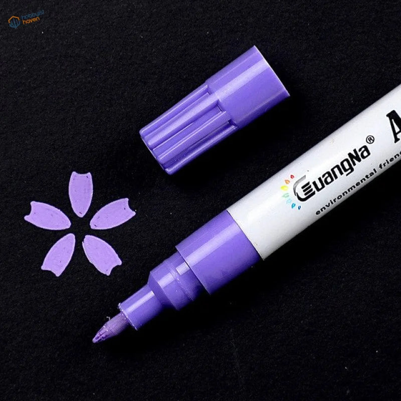 Purple 0.7mm acrylic paint marker pen with white barrel next to flower mark