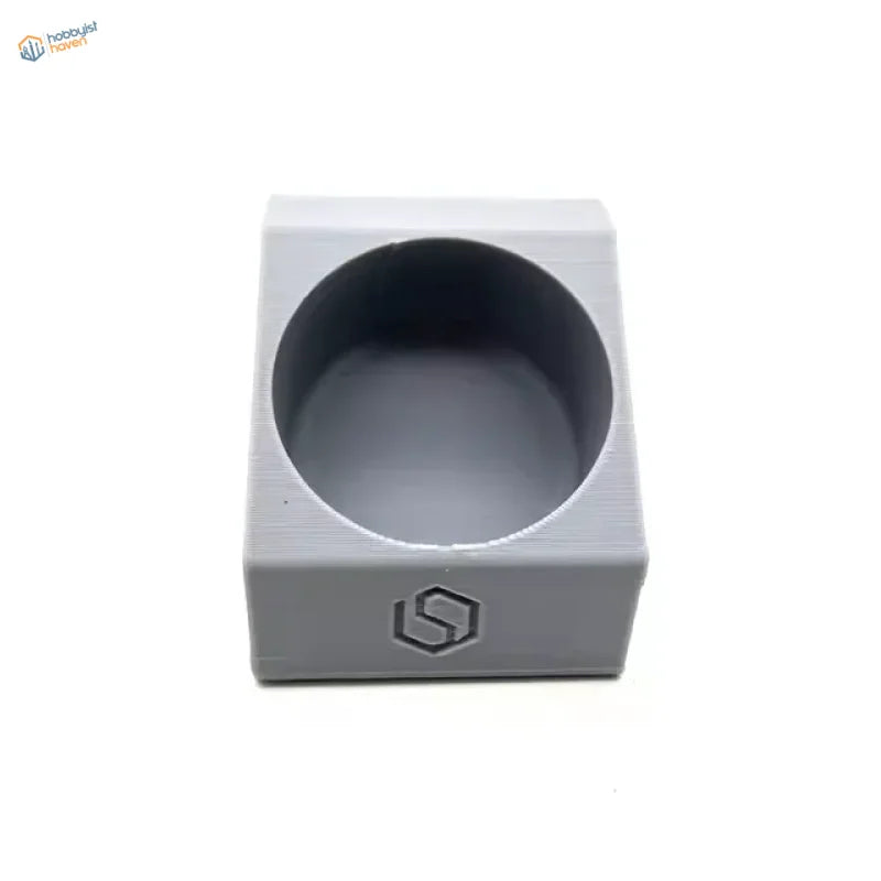 Gray 3D-printed glue holder with hexagonal logo for scale modeling tools