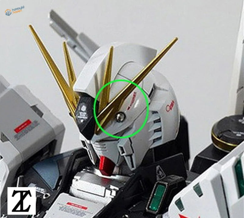 White and gold Gundam head with cylindrical metal golden antenna spikes