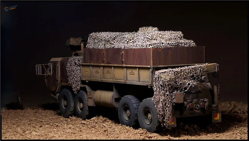 Detailed 1/35 military dump truck model with weathered paint and camouflage nets