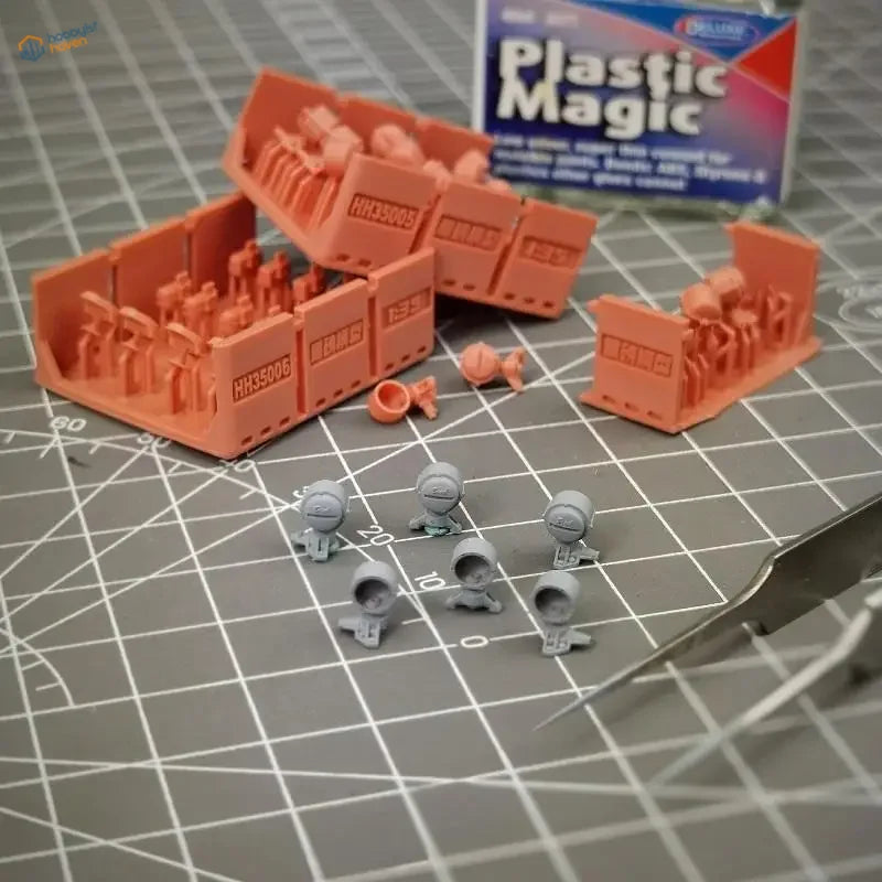 Orange plastic train containers with figures near 1/35 Bosch lamps for Panzers