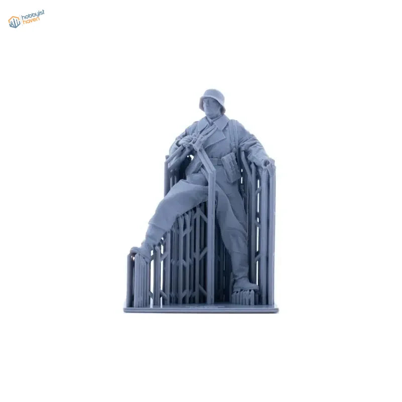 Gray plastic 1/35 German motorcyclist figure seated on ornate chair