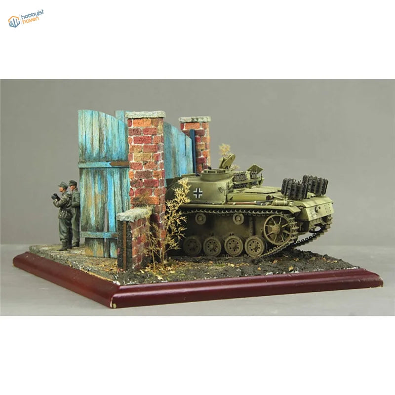 1/35 olive green German tank model with black cross beside European wooden door scenario