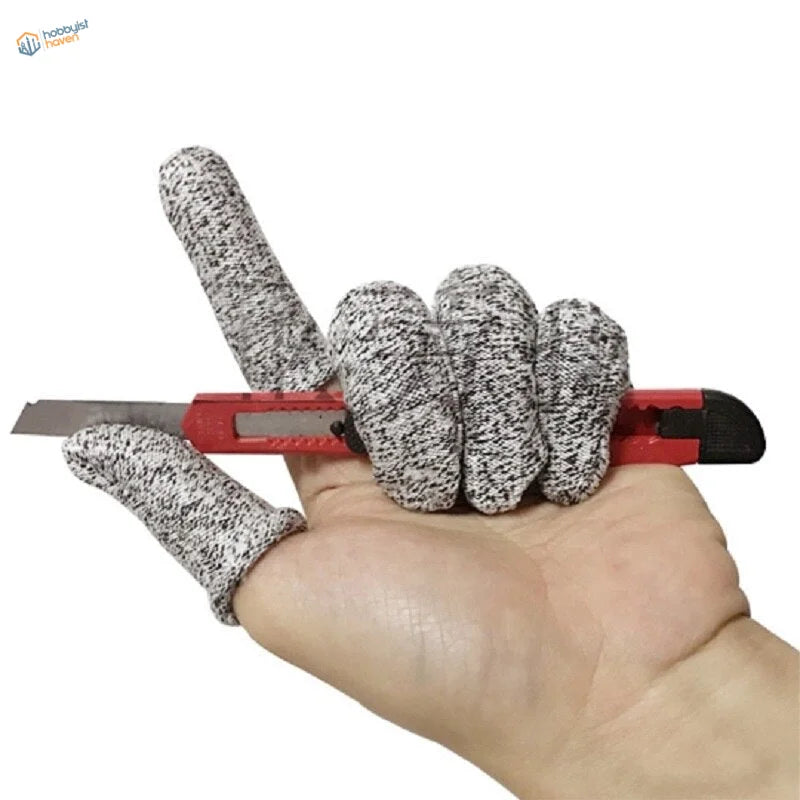 Gray white speckled level-5 safety finger sheaths on hand holding red utility knife