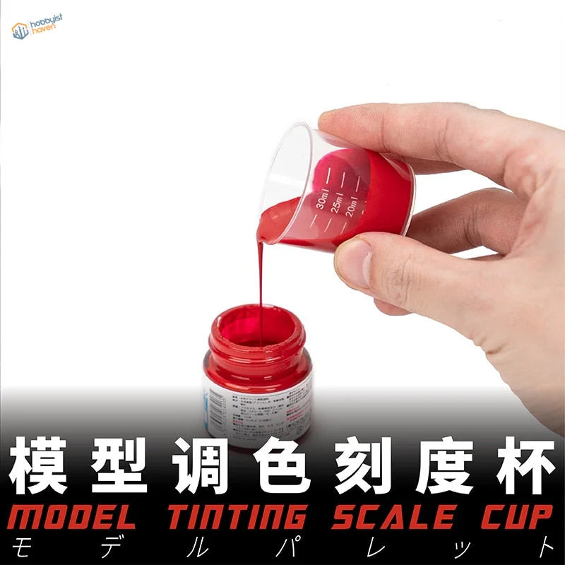 Transparent mixing cup with red markings pouring vibrant red paint