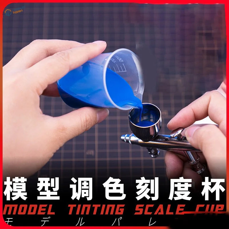 Transparent mixing cup with blue liquid and measurement lines