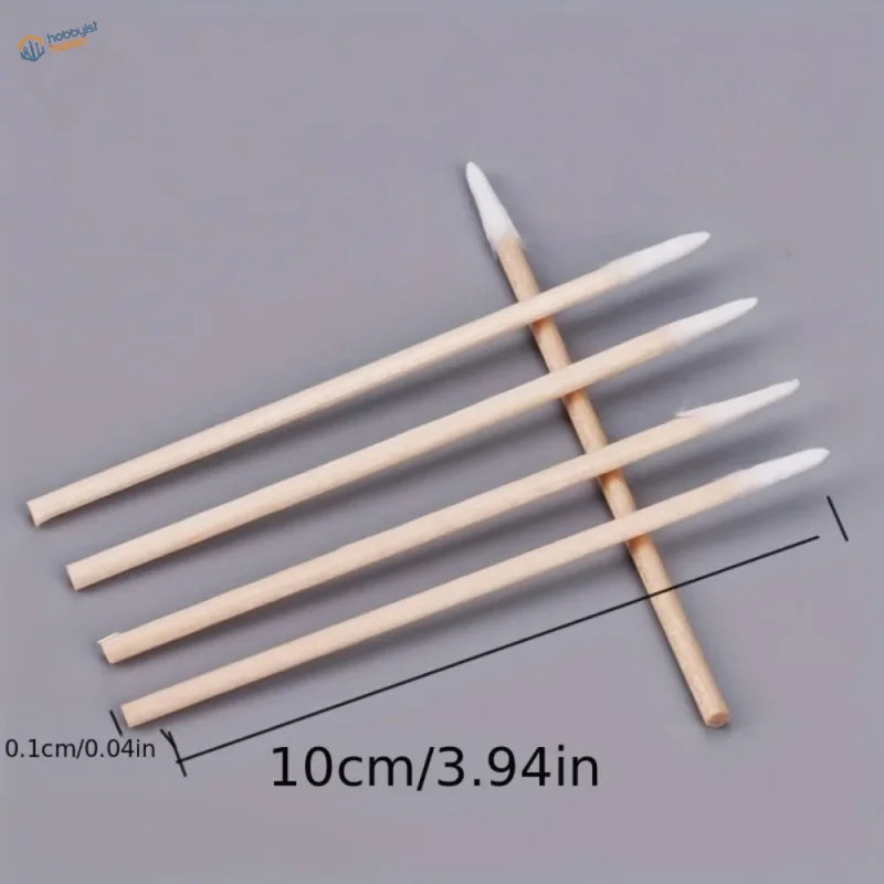 Five wooden-handled disposable micro cotton swabs arranged diagonally