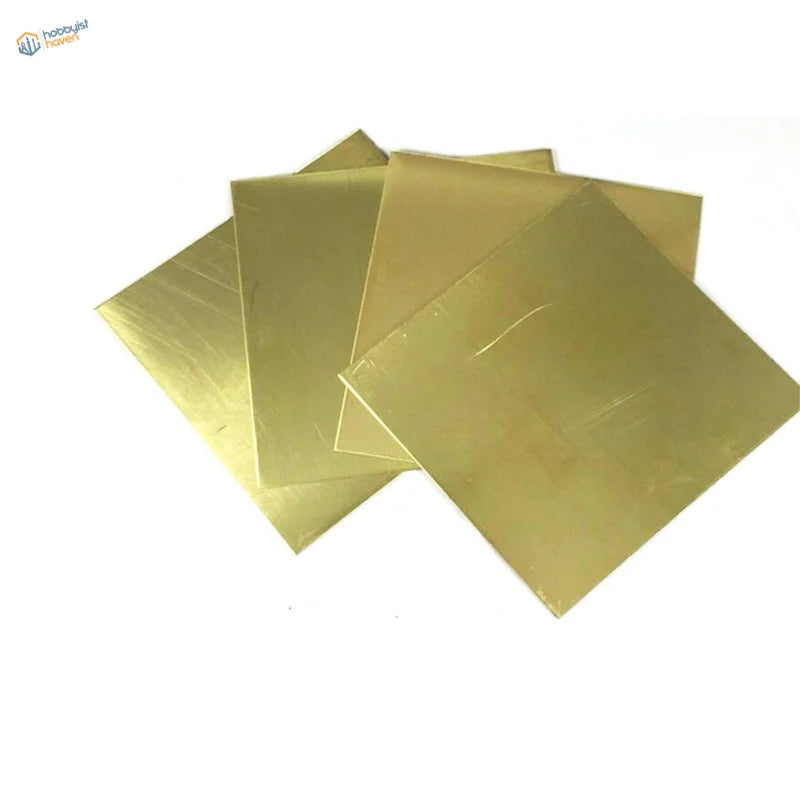 Stacked 100x100mm H62 brass sheets with golden hue and reflective surfaces