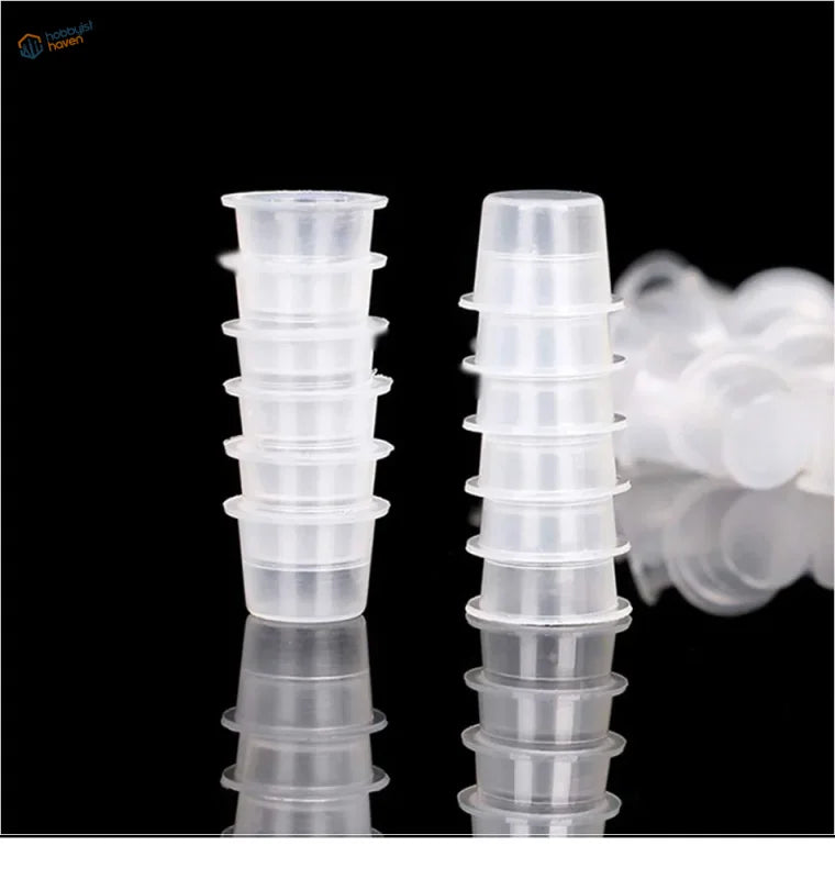 Clear disposable paint mixing cups stacked in two columns
