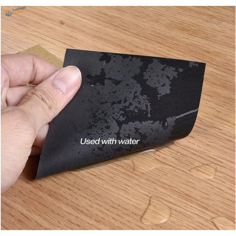 Back of 10pcs sandpaper for scale modeling: black abrasive with used with water text