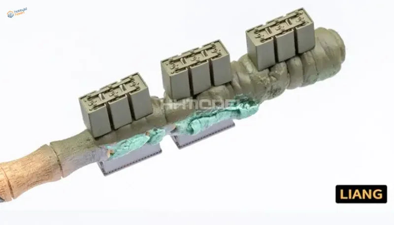 Back of olive-green 1/35 model storage battery with metallic connectors
