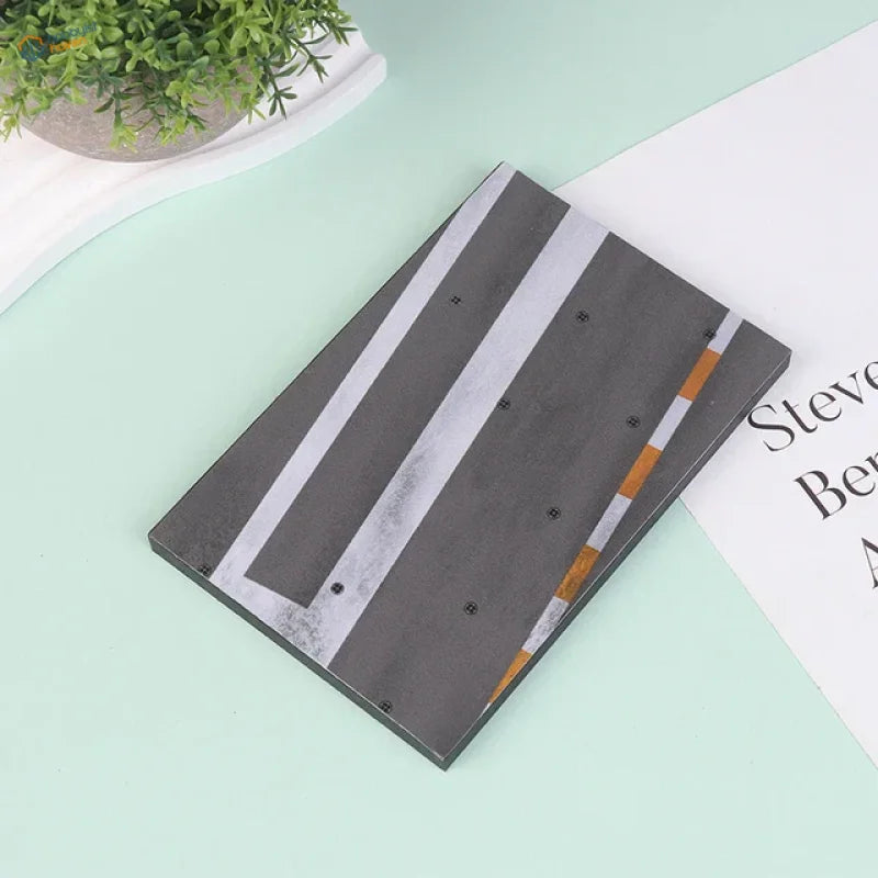 Gray notebook with realistic runway base design in white orange stripes