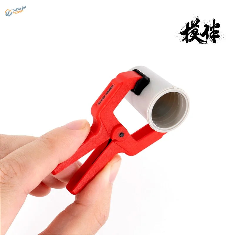 Red Galaxy model clamps gripping white PVC pipe
