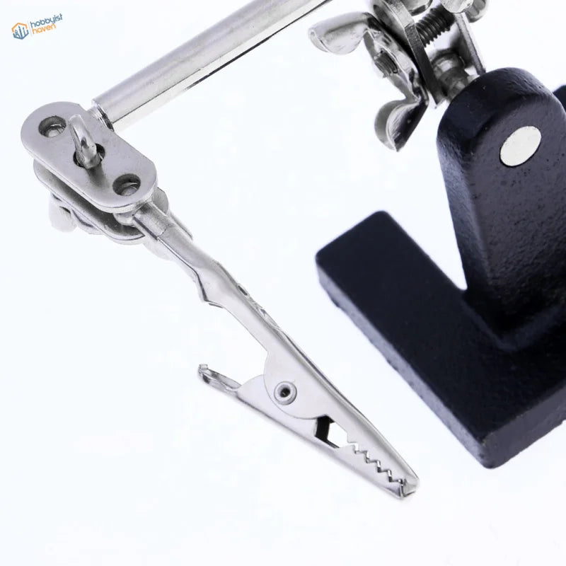 Silver alligator clips on 2.5x magnifying glass for soldering scale modeling