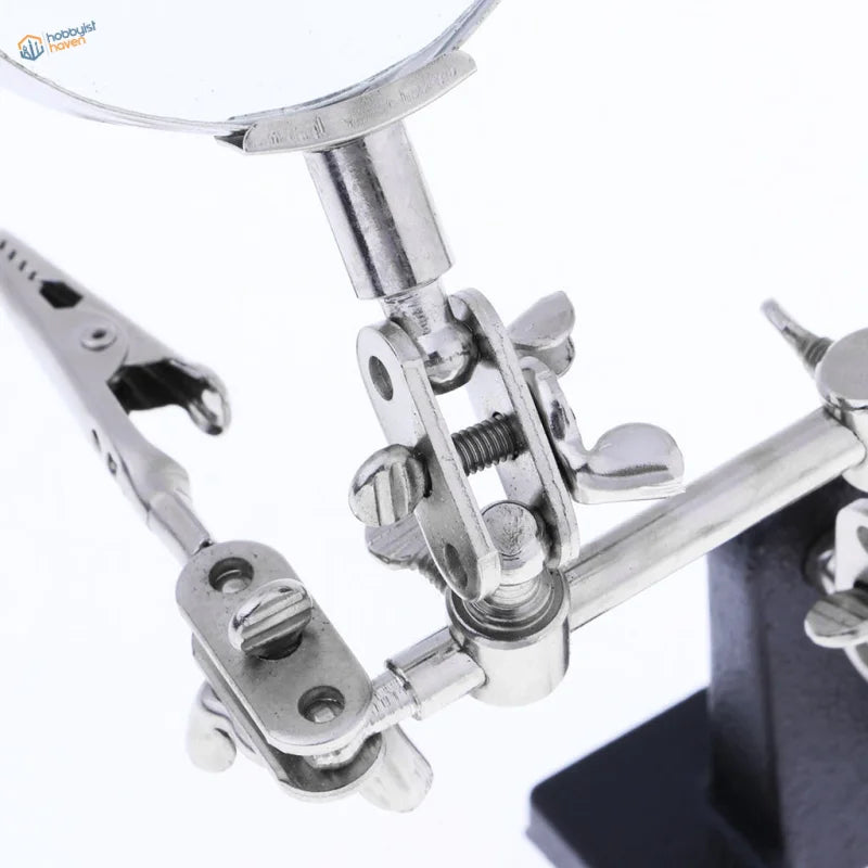 Silver-toned 2.5x magnifying glass with alligator clips for soldering scale modeling