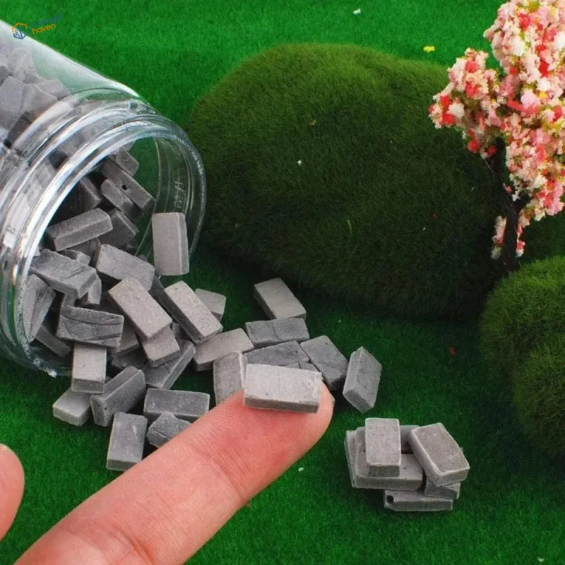 200pcs gray miniature bricks made of concrete spilling from a clear glass jar for diorama and scale modeling tools