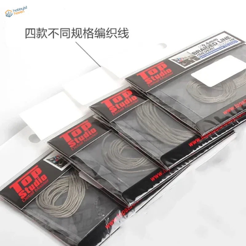 Four 2m braided lines in clear sleeves with Top Studio branding for scale modeling