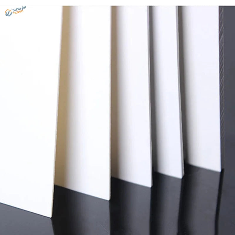 Stacked white and black styrene sheets for scale models, 100x200mm