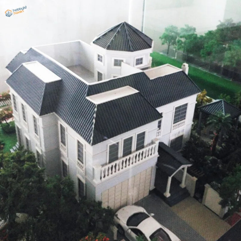White two-story house model with black tiled PVC roof panels and balconies