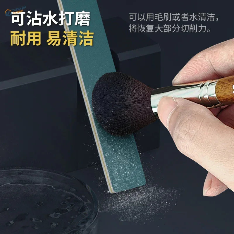 Hand with semi-rigid sanding stick brush scrubbing green pad