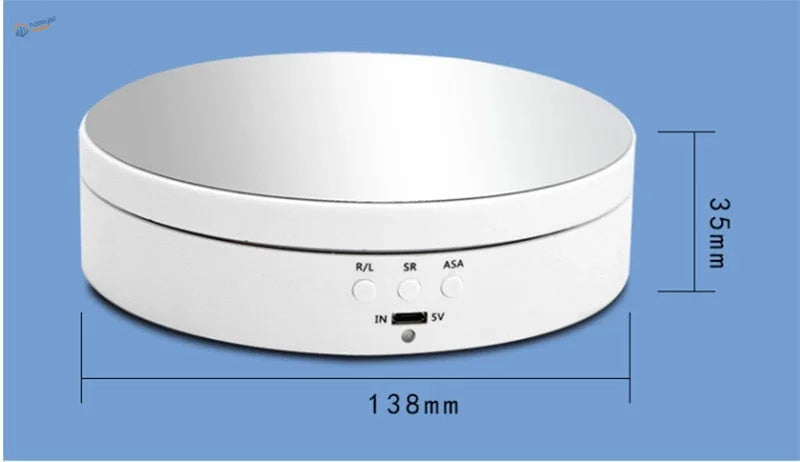 White circular rotating display stand with a smooth, glossy finish and labeled control buttons.