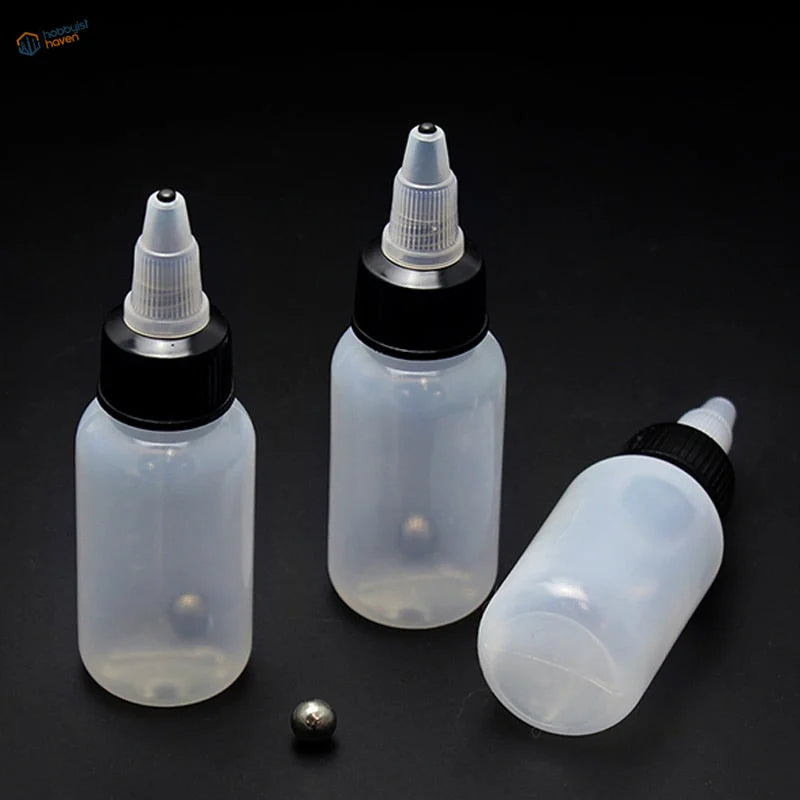 Three 30/60/120ml translucent squeeze bottles with steel mixing ball, one on side