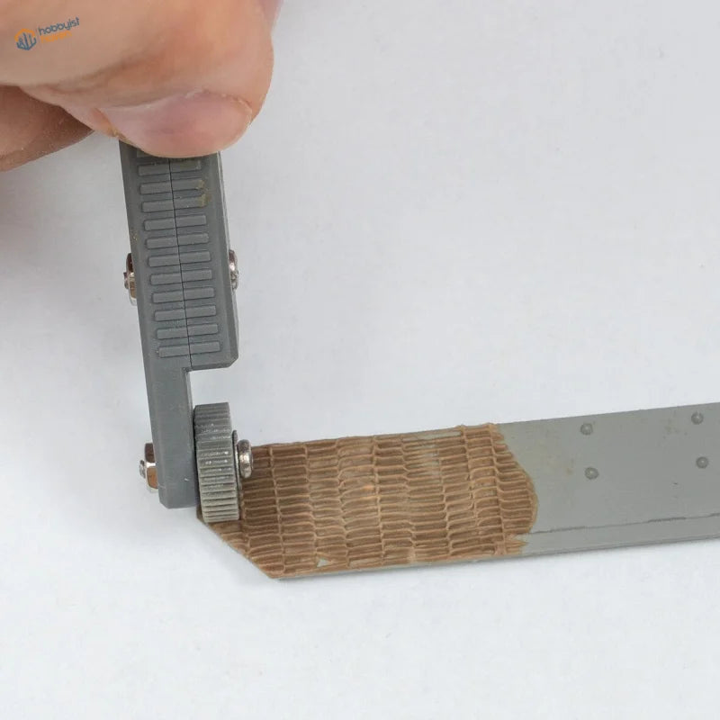 3D printed tool for zimmerit modeling: gray caliper measuring metallic ruler