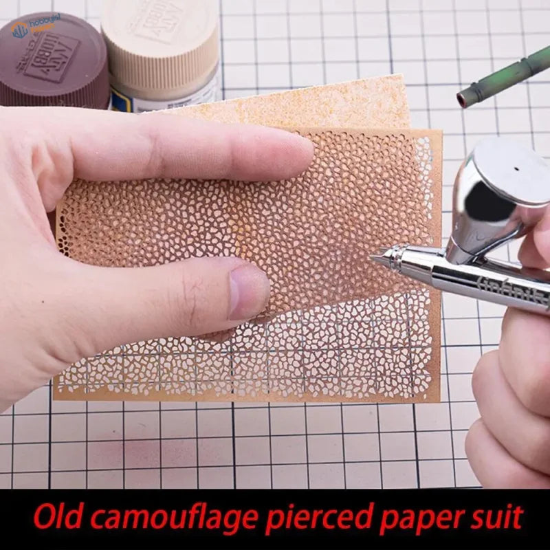 Tan craft paper marbling stencil with perforated camouflage pattern airbrushed