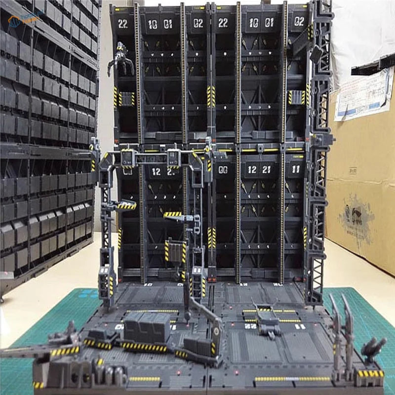 Black plastic Gundam mechanical base with yellow hazard stripes and numbered compartments