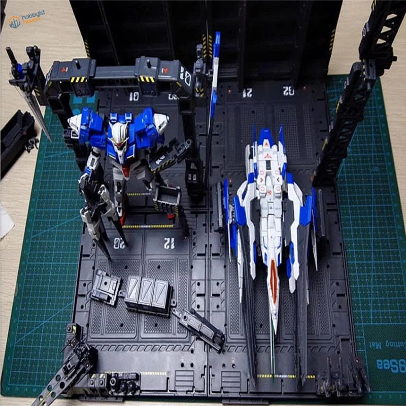 Blue and white Gundam on black Gundam mechanical base with red accents