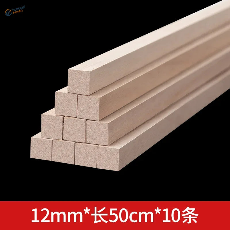 Stack of light-colored balsa wood square rods, unfinished and smooth