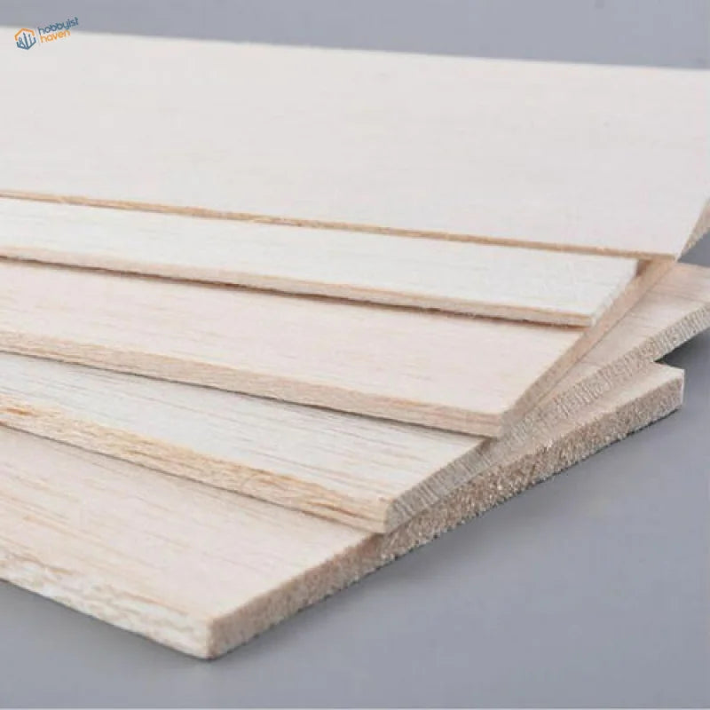 Light-colored balsa wood sheets with visible grain and smooth unfinished surface