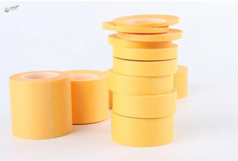 5 pieces masking tape: stacks of bright yellow adhesive rolls