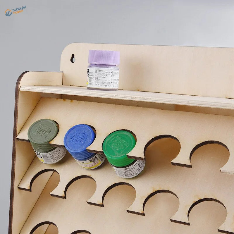 Light beige wooden rack with green, blue, purple paint pots for scale modeling