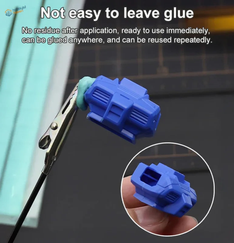 Blue plastic reusable tack applicator with green silicone tip for scale modeling