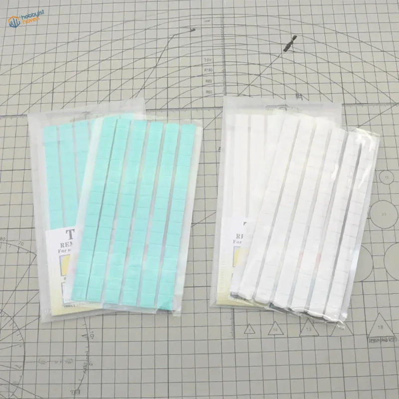 Two 50g reusable tack packs on scale modeling tools cutting mat