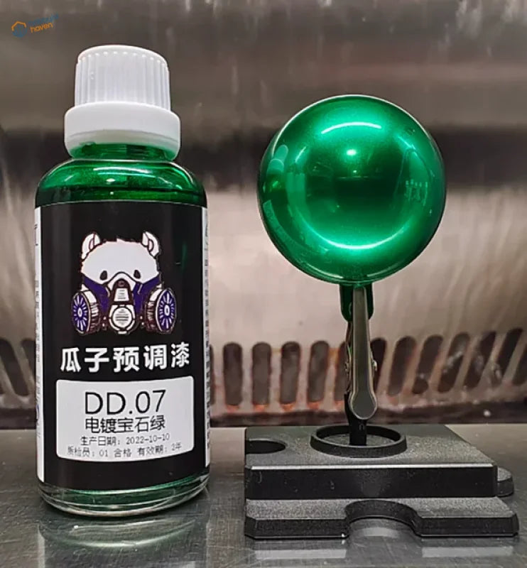 50ml electroplated mirror-chrome model paint in metallic green on a black stand