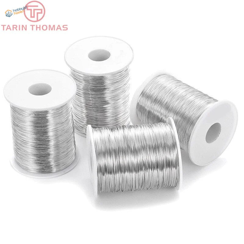 Four spools of silver brass steel wire, 5m 0.3-0.8mm with white cores