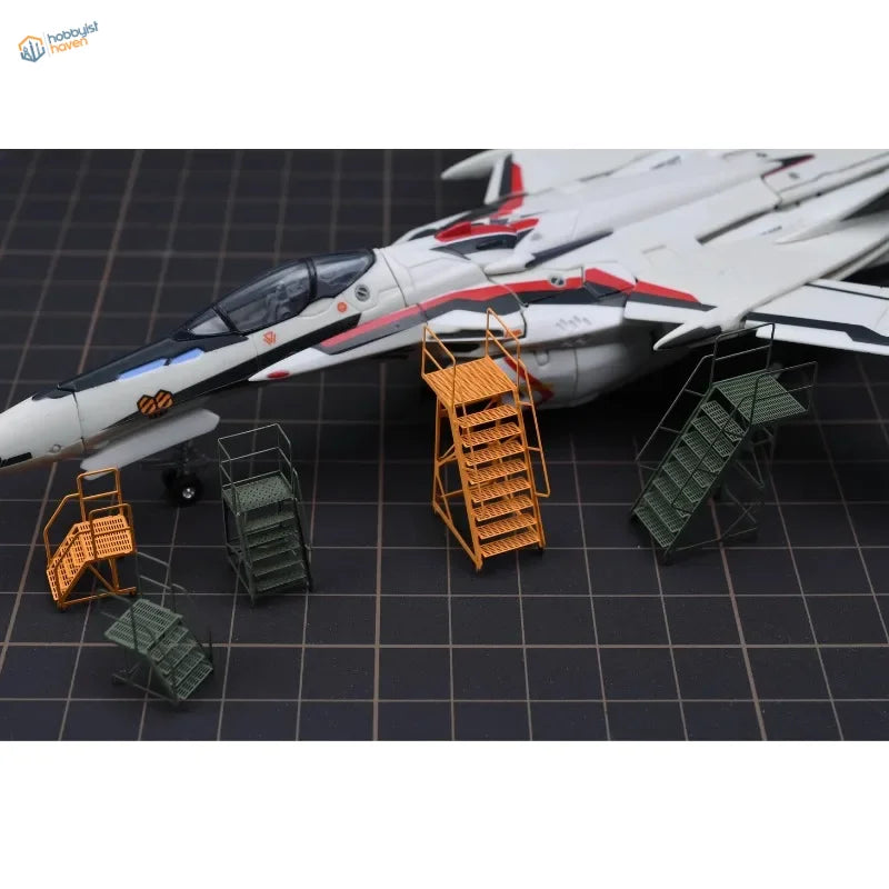 White and red VF-1S Super Fighter scale model with maintenance ladders