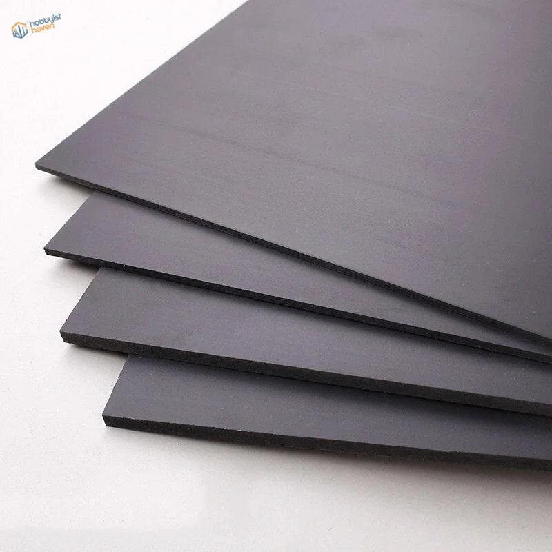 Black matte styrene sheets stacked neatly for scale modeling