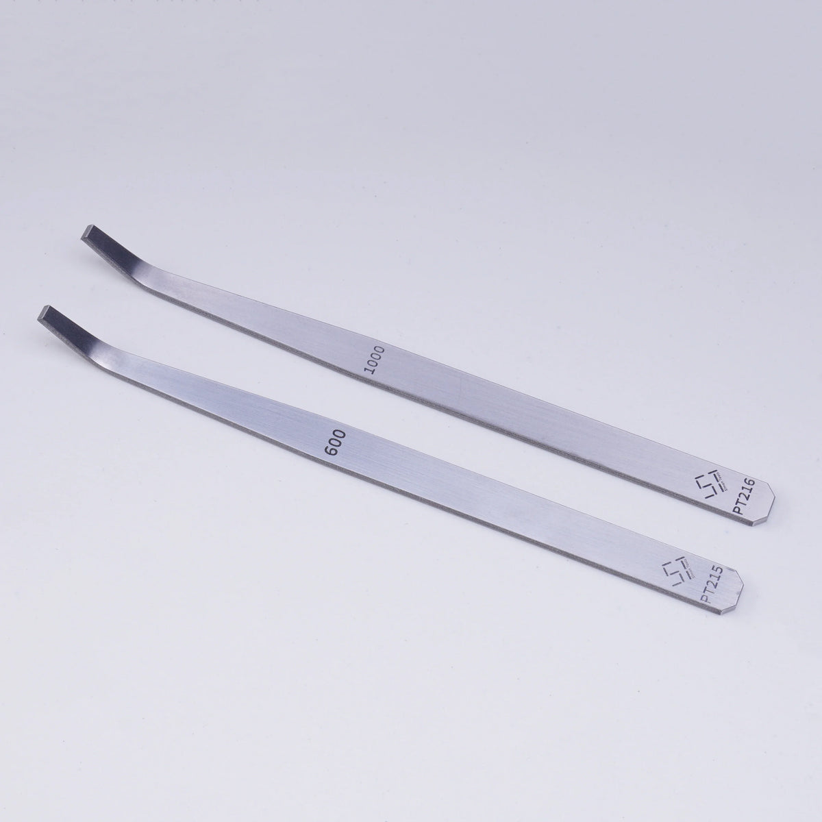 Silver curved-tip tweezers on 600#/1000# precision angled file
