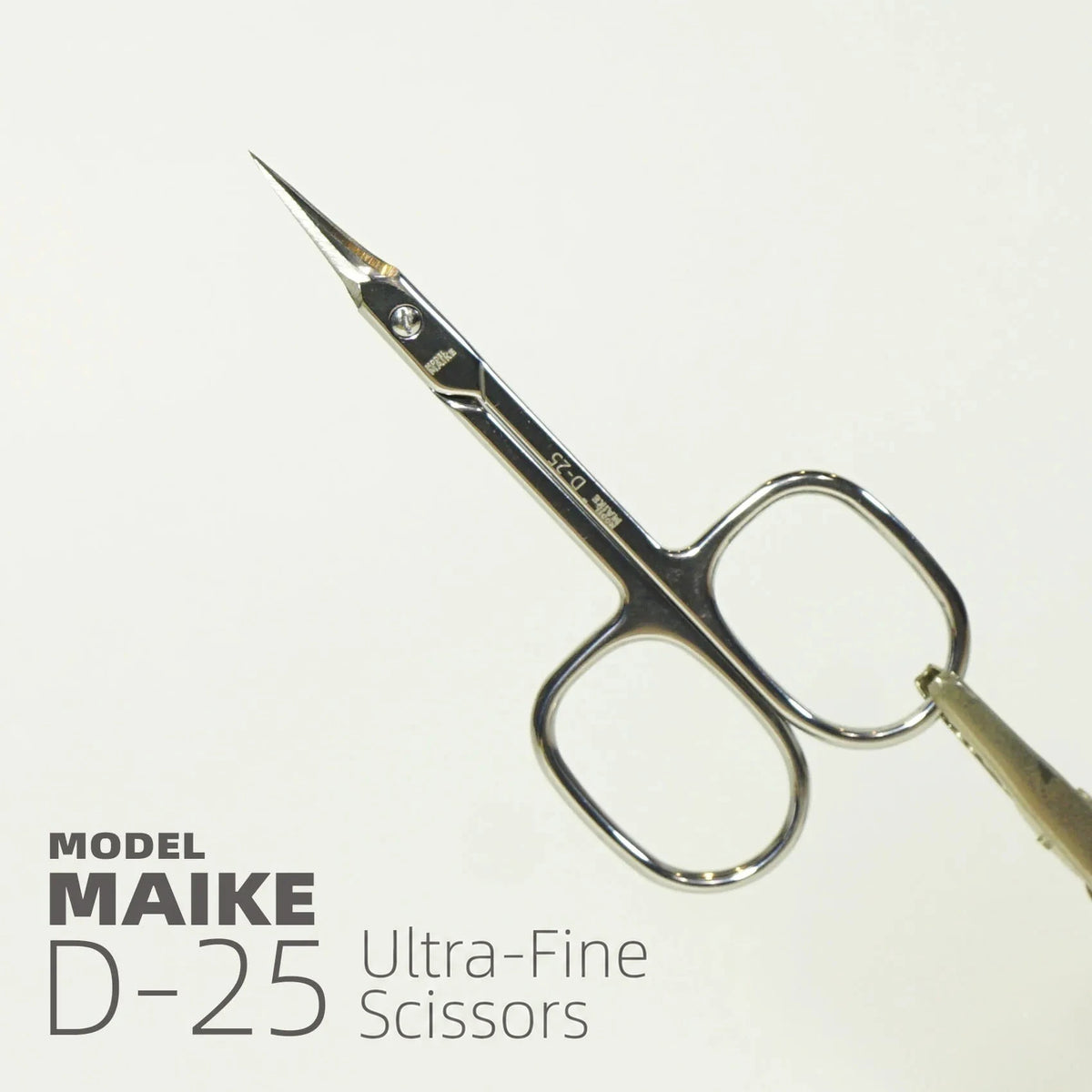 MAIKE D25 scissors held open to show the fine curved blade tips