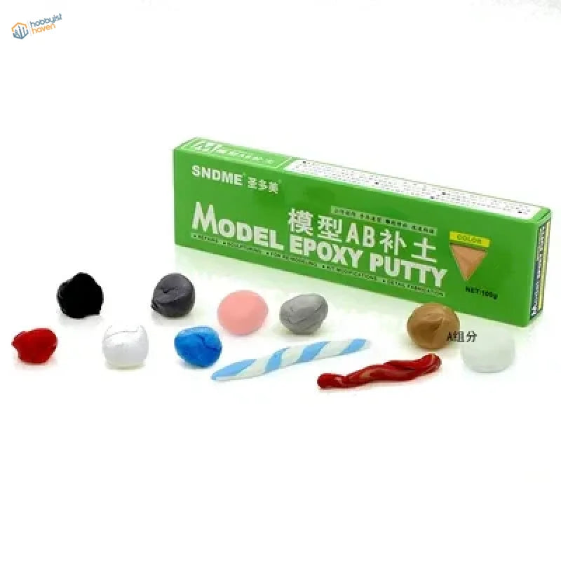 Green box of sndme model epoxy putty with assorted colored clay balls and sculpted pieces for scale modeling tools