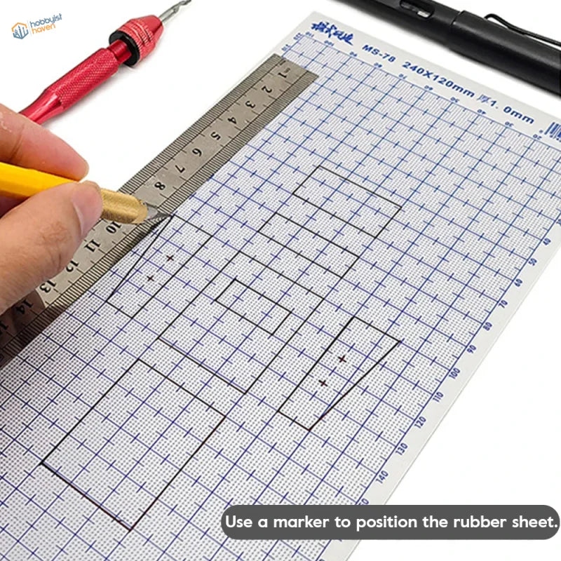 A transparent abs plastic modeling sheet with blue grid markings and a metallic ruler on a cutting mat